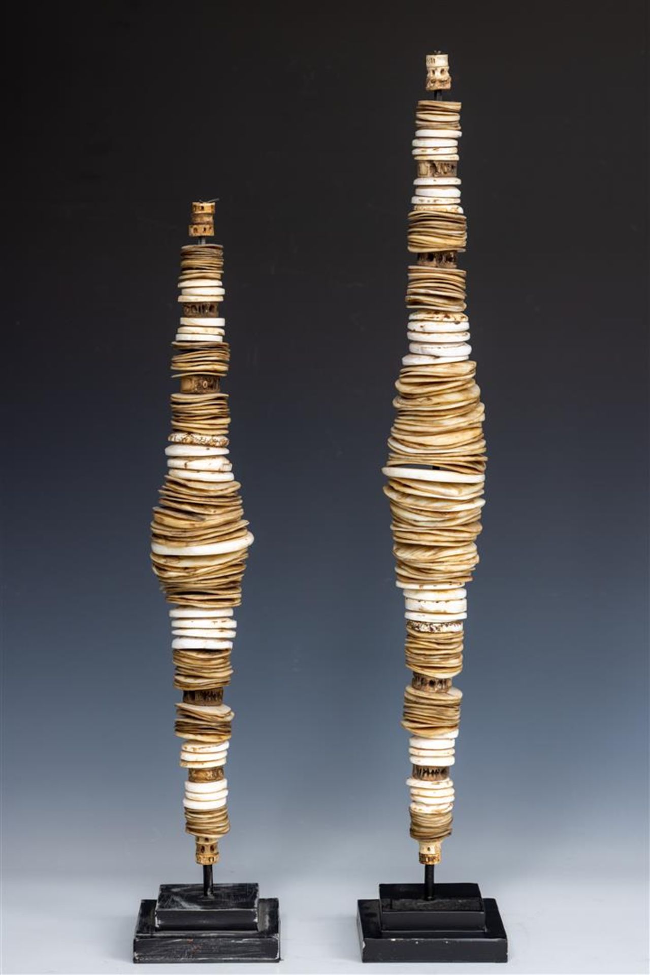 A lot consisting of (2) decorative objects made of shell money.