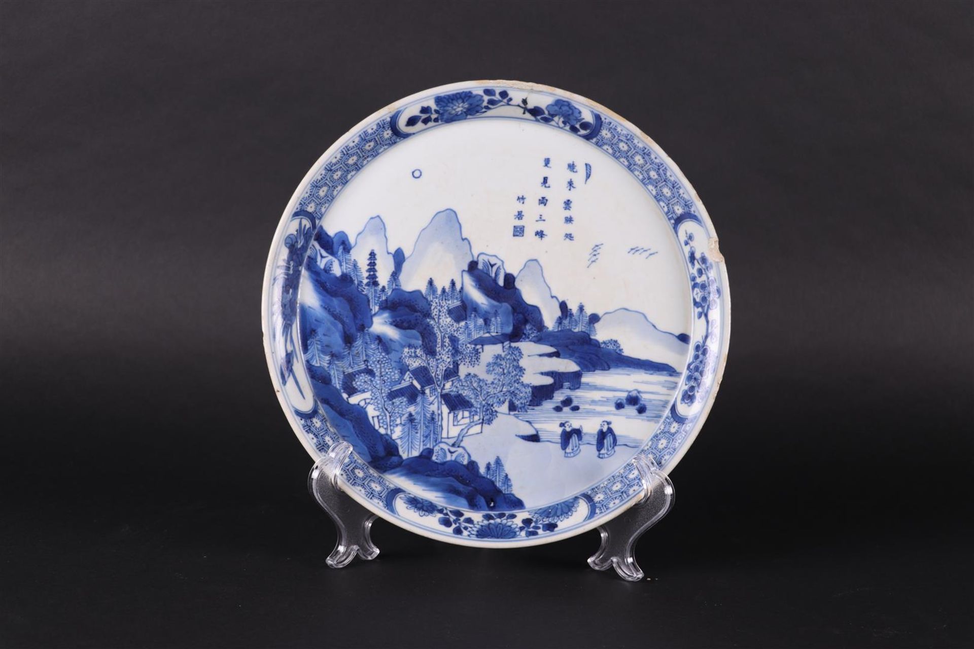 A porcelain dish with landscape decor and decorated with various Chinese characters. 