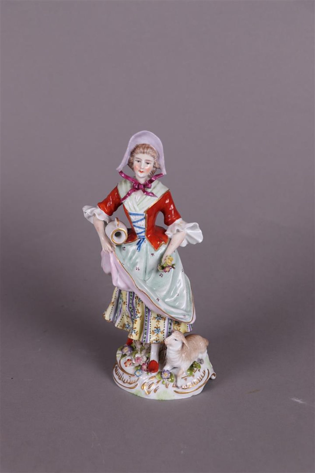 A porcelain figure of a girl holding  a jug and flowers, marked Sitzendorf Thüringen. 