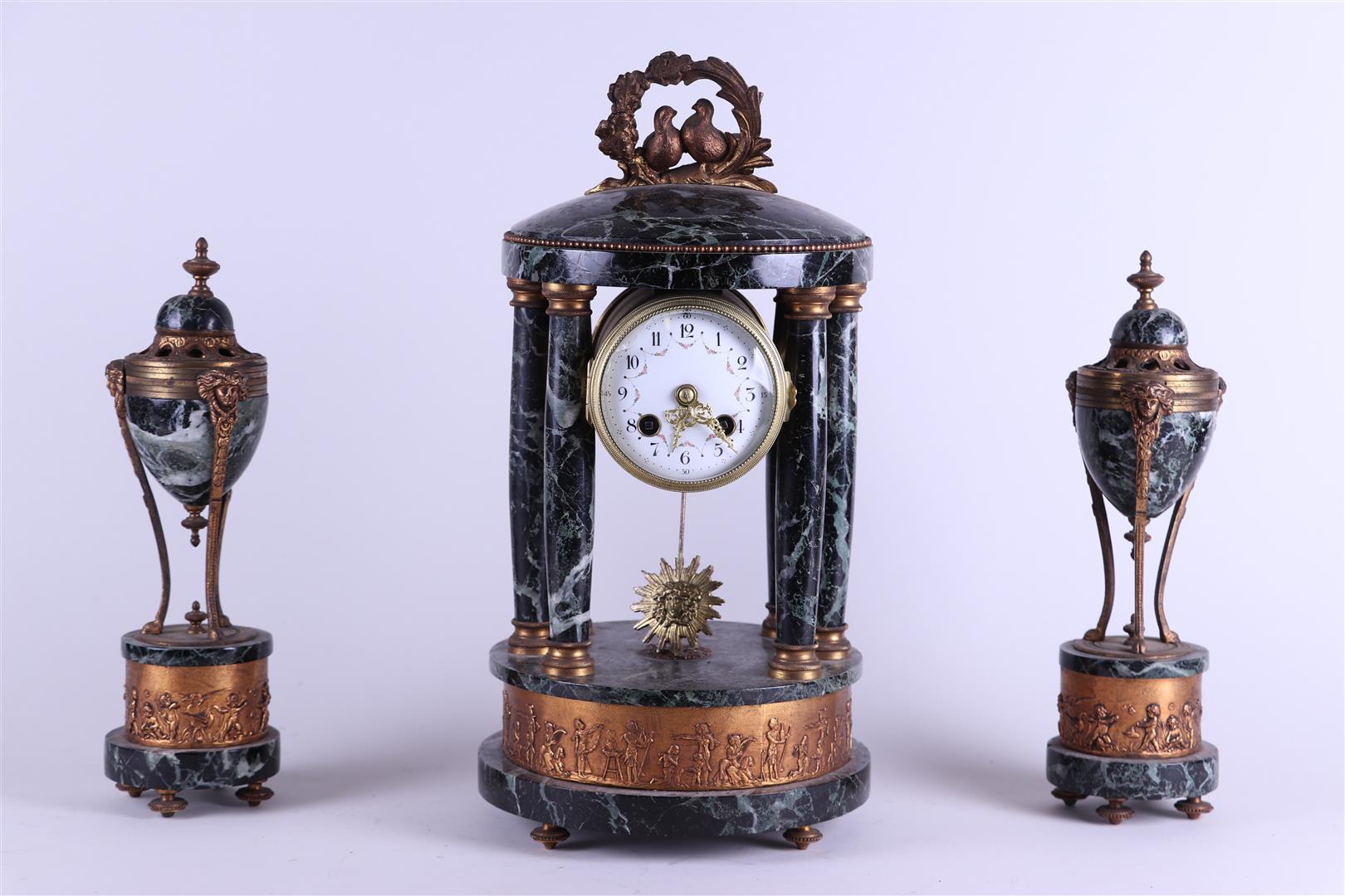 A green marble Garniture de Cheminee consisting of a column clock and two casolettes