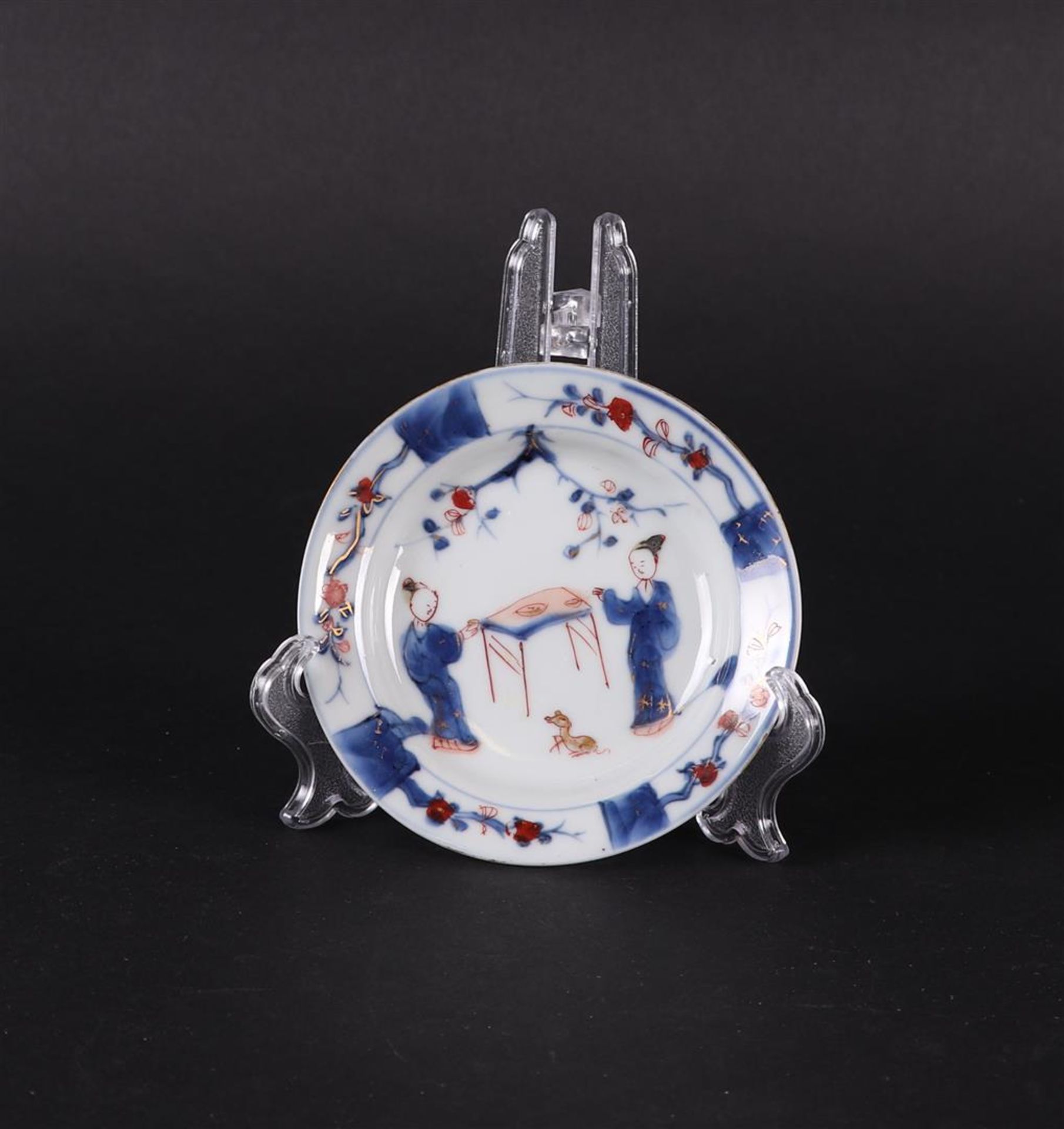 A porcelain Imari plate with long  Elizas at the table and a rat. China/Japan 18th century.