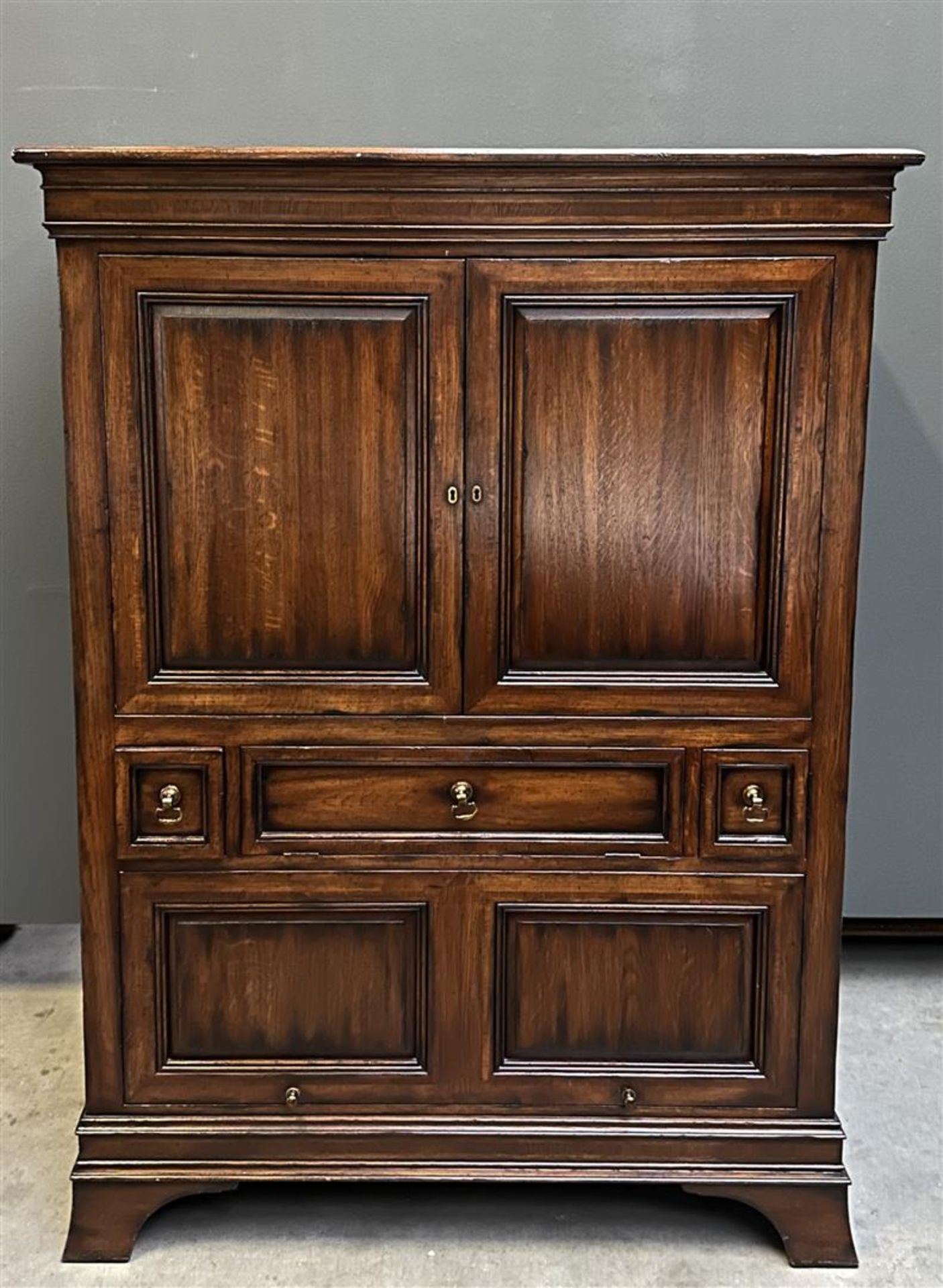 A chestnut wood china cabinet, after an older example. In very good condition.