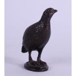 A brown patinated bronze of a quail