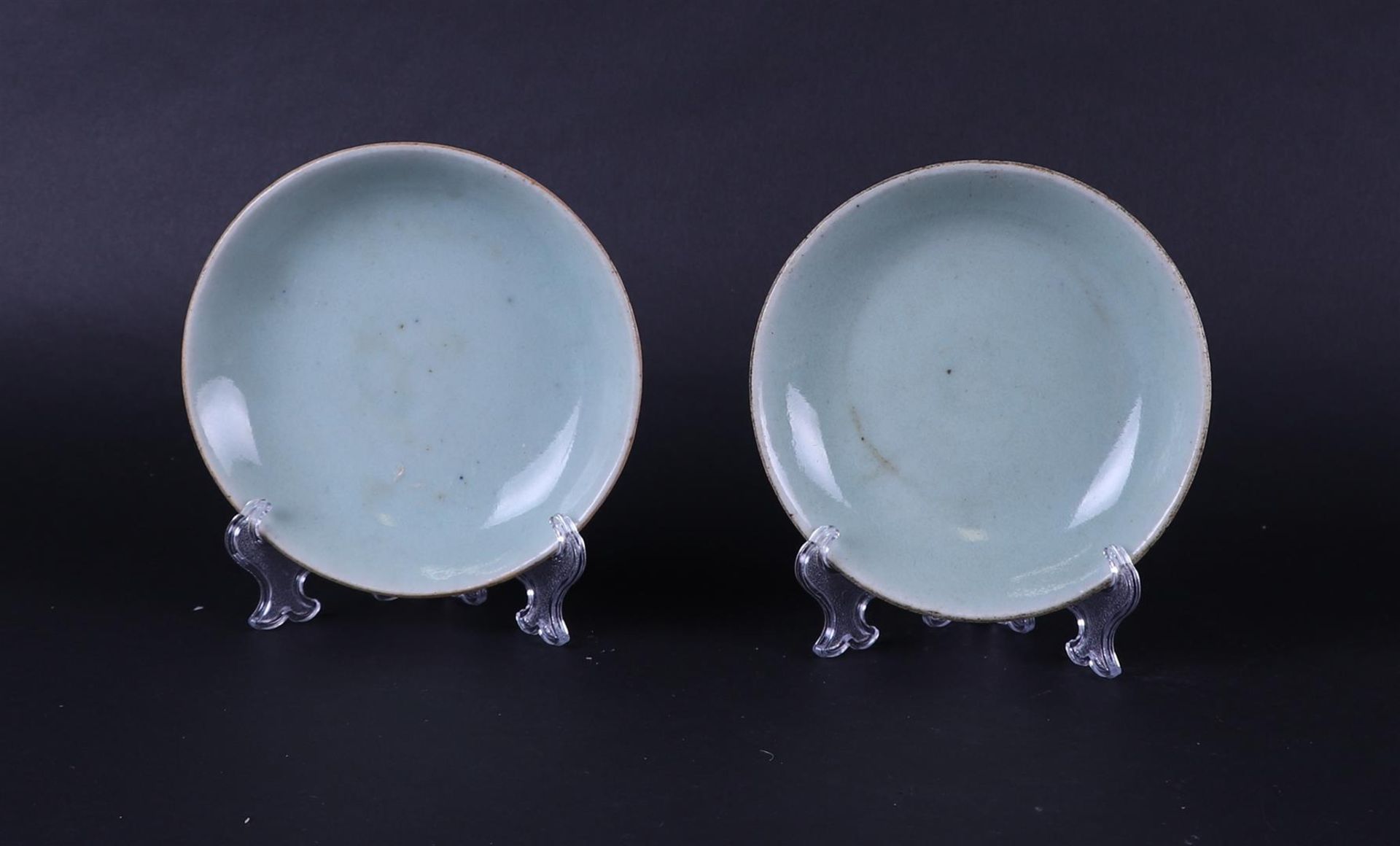 Two Celadon dishes with seal mark on the bottom. China, Ming and later.