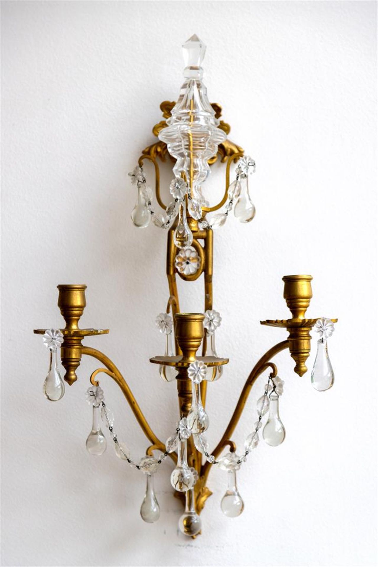 A set of two bronze wall chandeliers with glass icicles