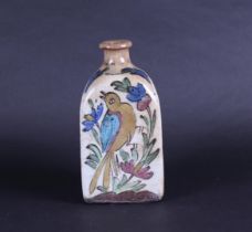 A Qajar pottery bottle decorated with decor of animals and plants. Persia, 19th century.