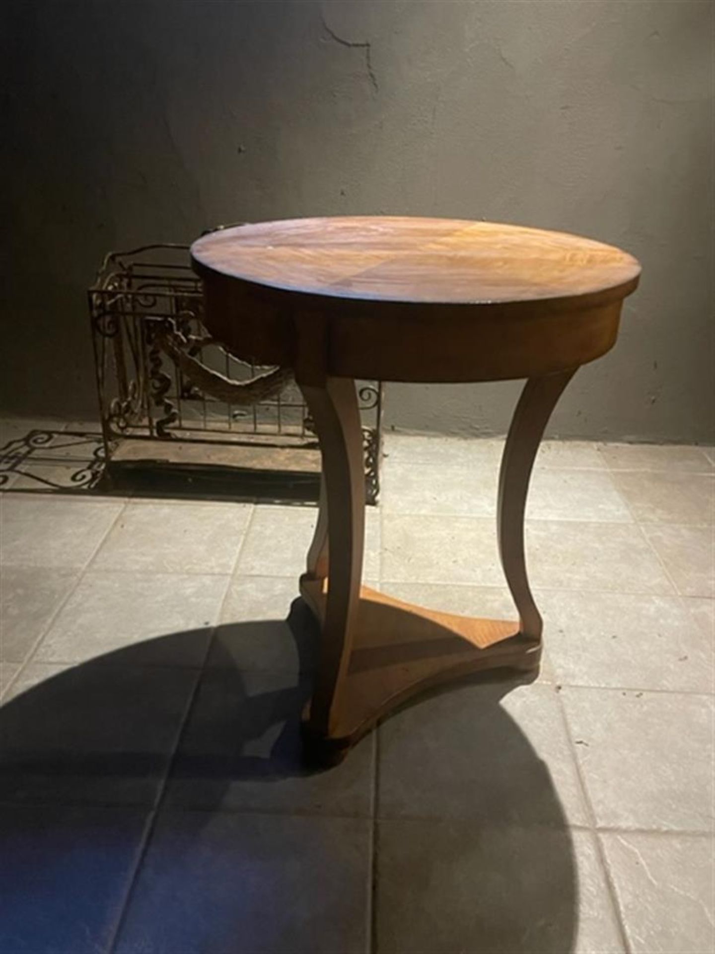 A round mahogany glued high plant table on three legs, ca. 1900