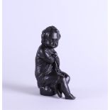 A 19th century brown patinated bronze of a putto, personification of winter.