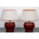 A pair of oxblood red, bamboo, lamp bases with a modern shade