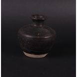 A large stoneware storage jar, dark grey. China early Ming.