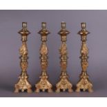 A lot consisting of a set of four bronze altar candlesticks. Late 19th century.