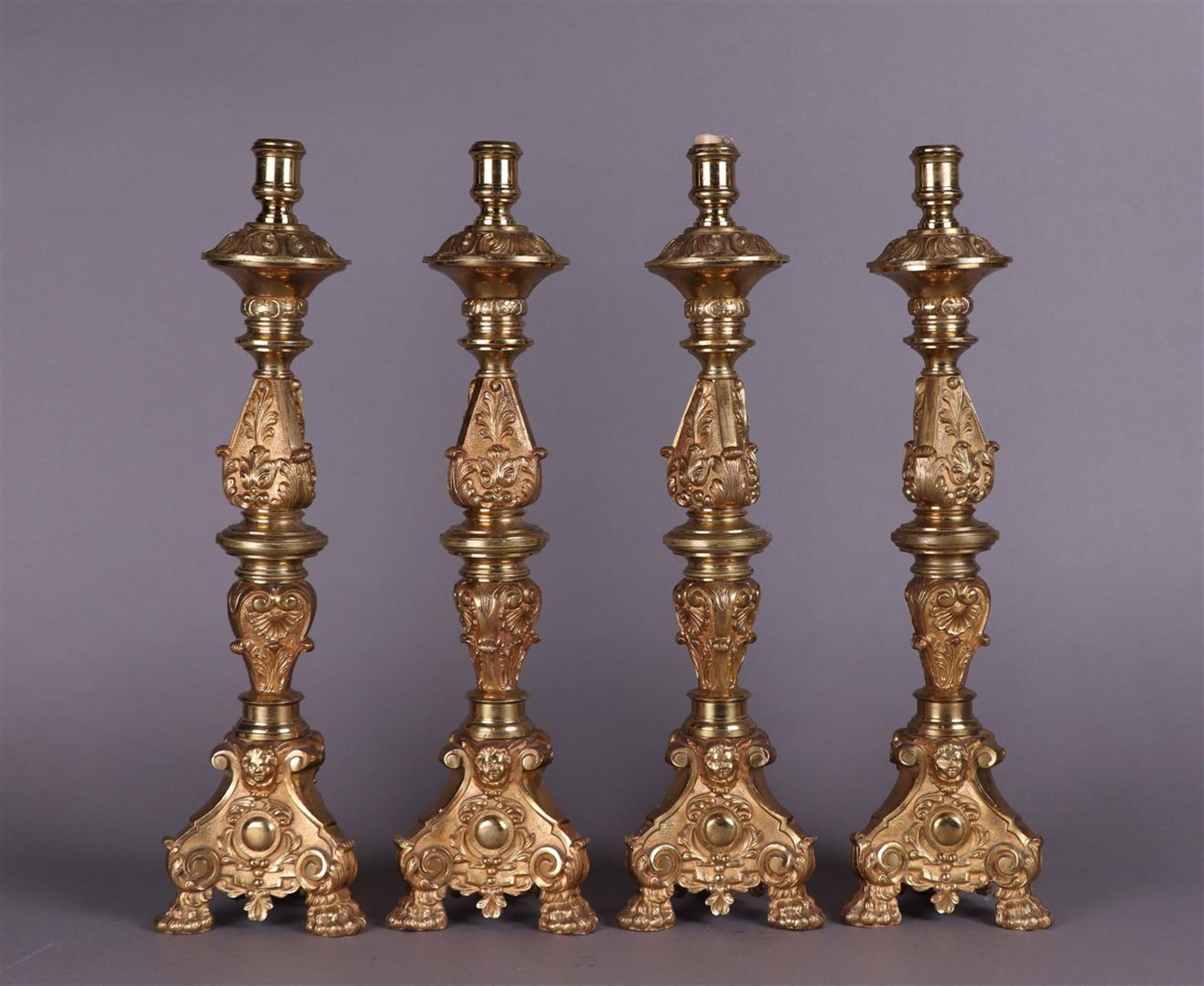 A lot consisting of a set of four bronze altar candlesticks. Late 19th century.