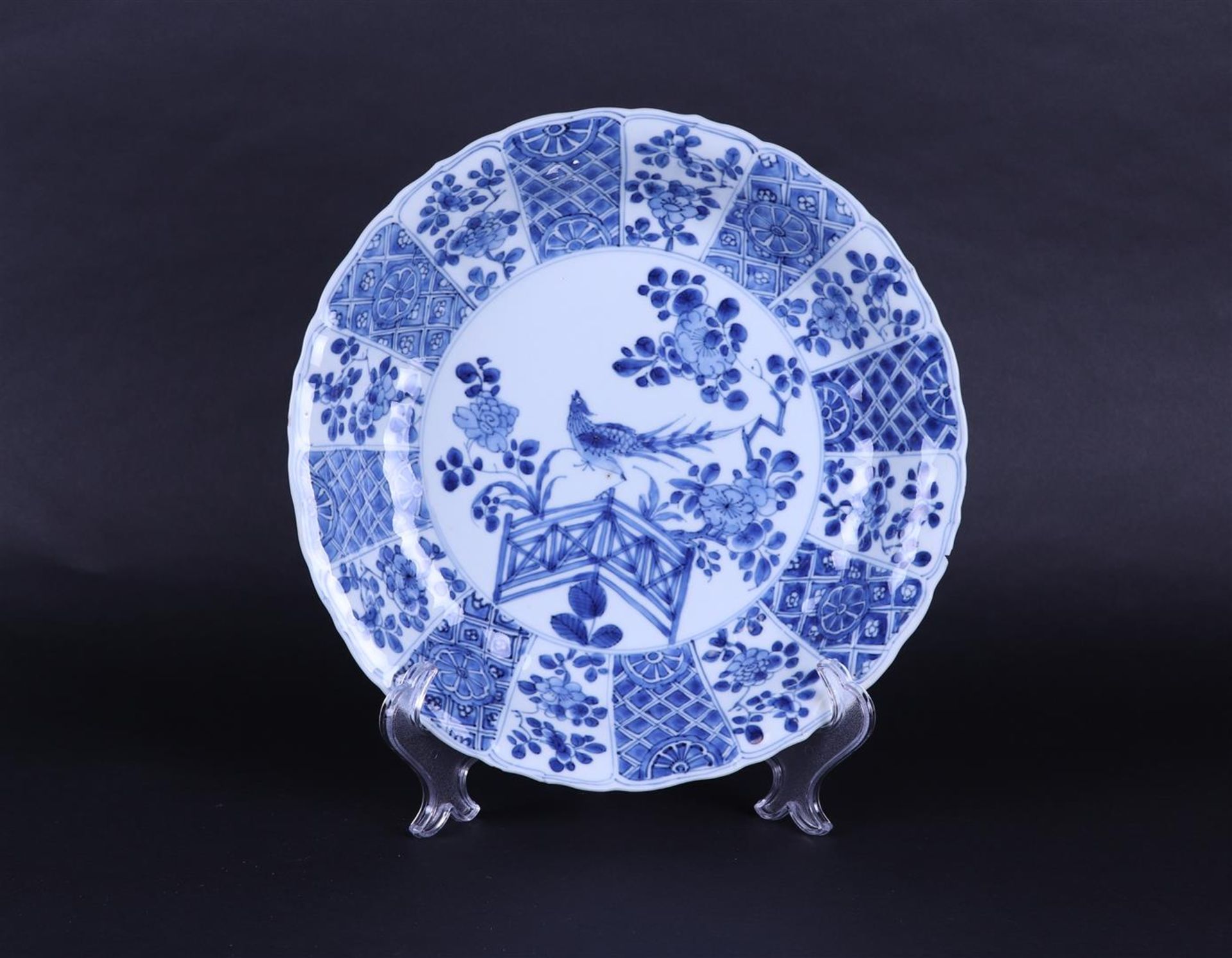 A porcelain dish decorated with a pheasant by a fence. China, Kangxi.