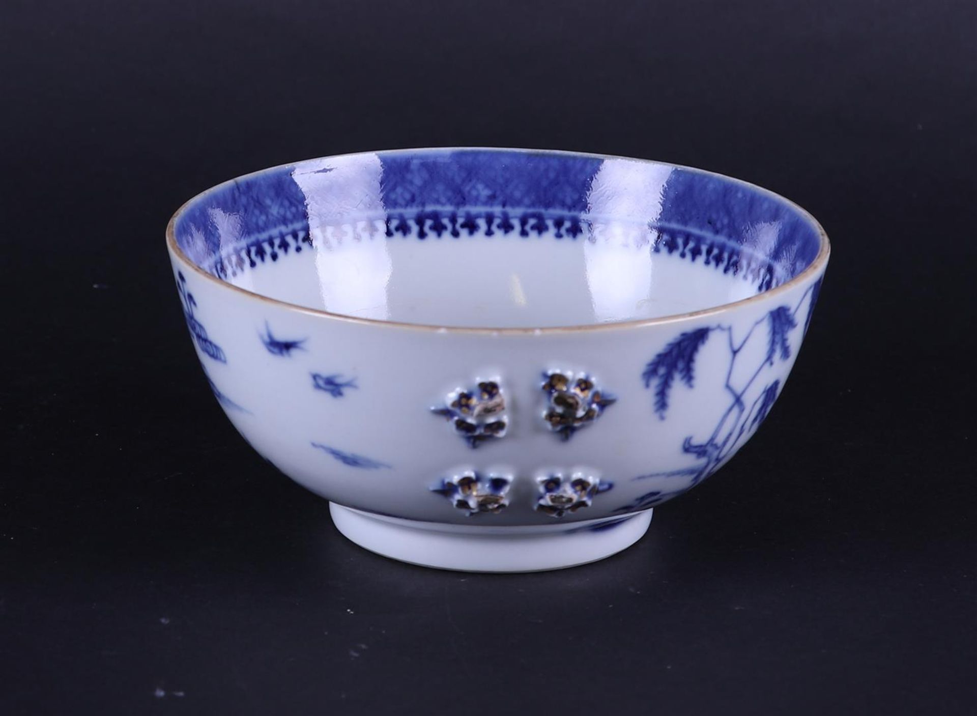 A porcelain bowl with river landscape decor on the outside and embossed flowers on the outside.  - Image 2 of 5