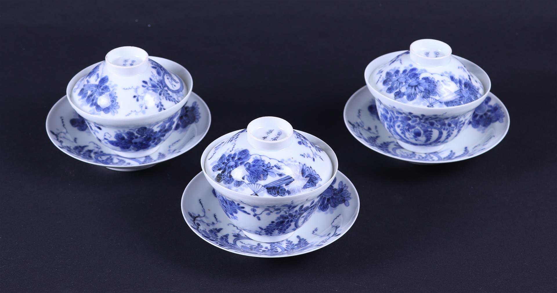 A set of three blue and white lidded cups and saucers, marked. Japan, 19th century.