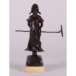 J. Pilar (1870 - 1930) . Viennese bronze sculpture of a Dutch farmer girl with a rake
