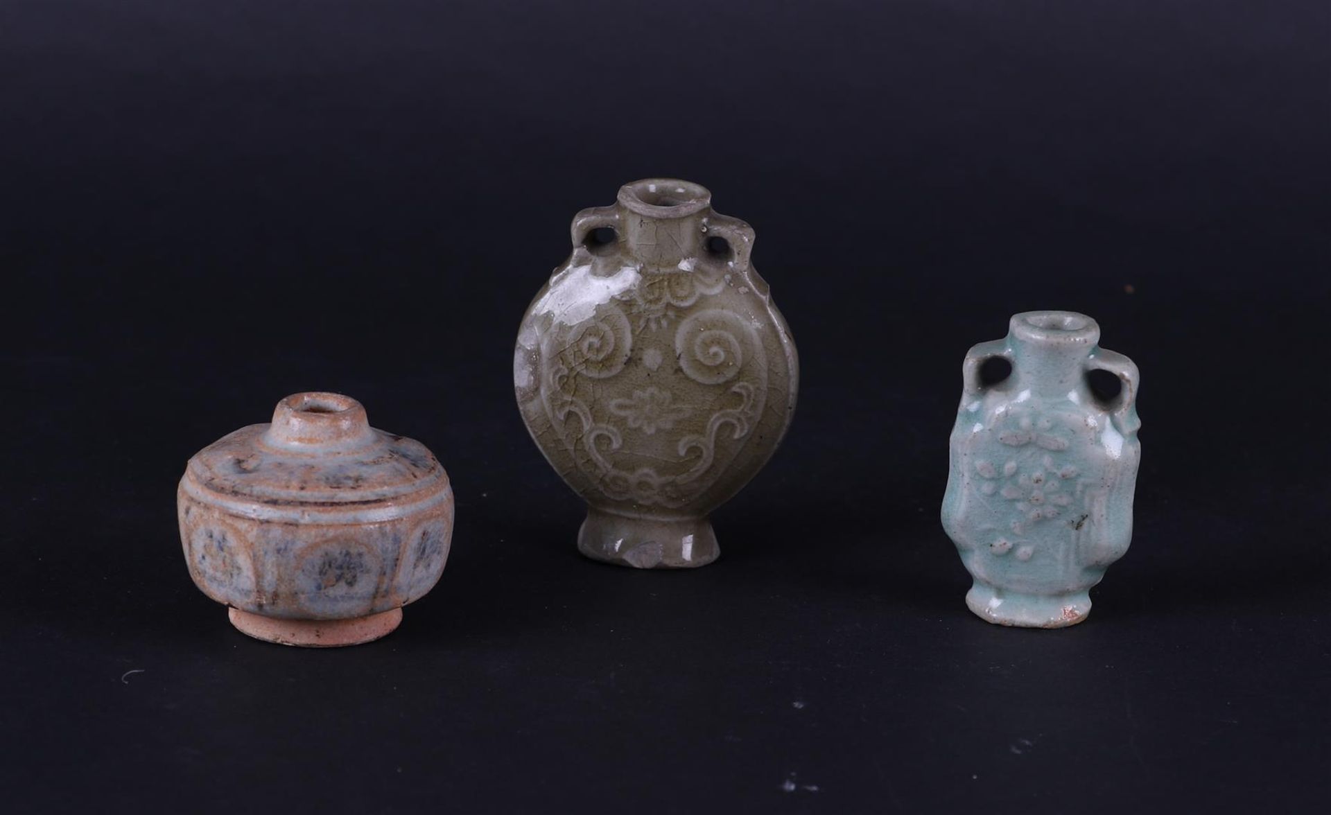 Two small Celadon vases with relief decoration and loop-shaped ears, a burial jar China, Ming