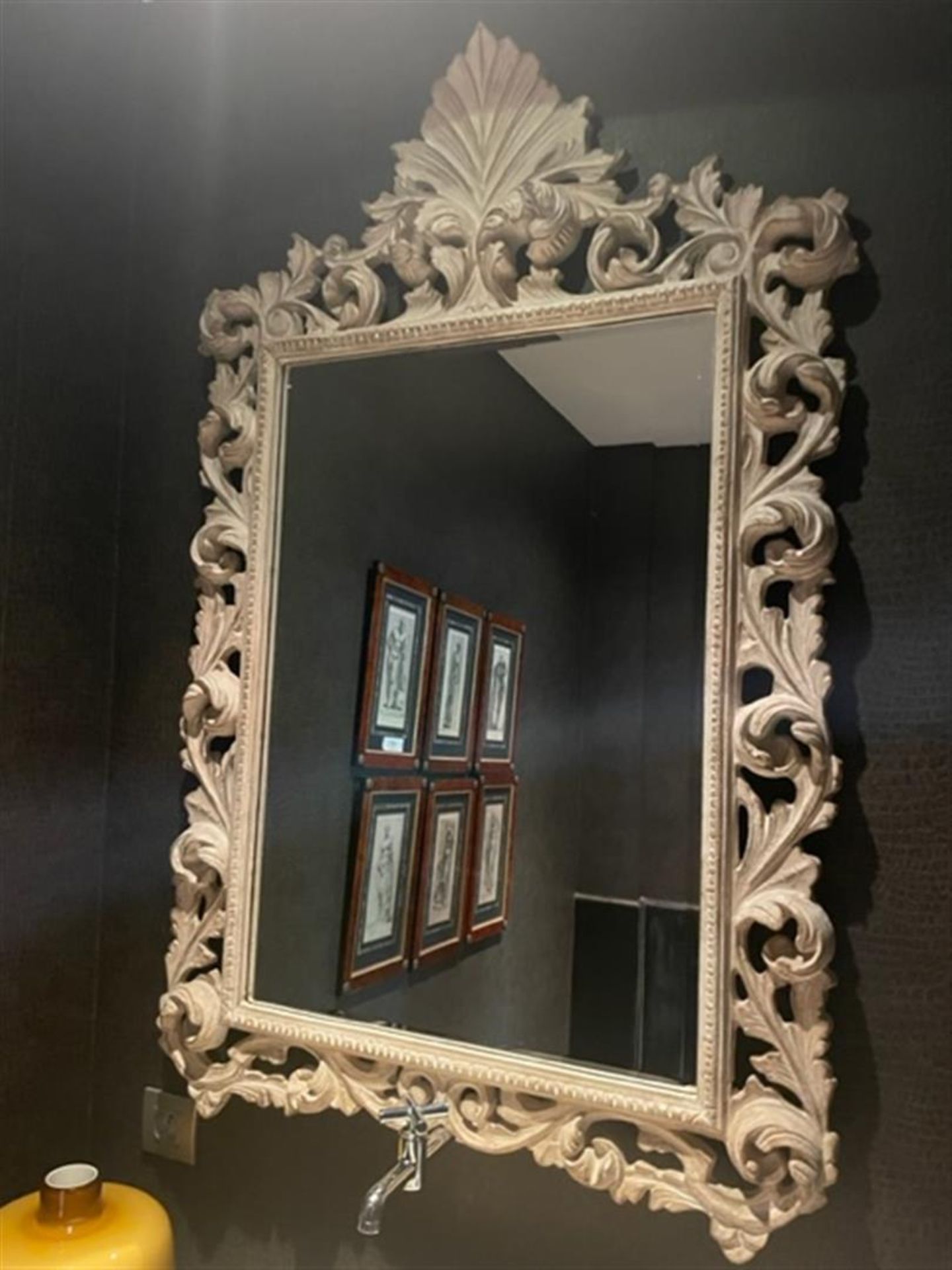 A gray carved mirror with cut glass.