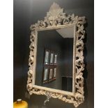 A gray carved mirror with cut glass.