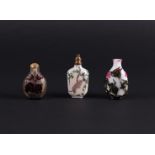 A lot of three snuff bottles including some in enamel. China, 20th century.