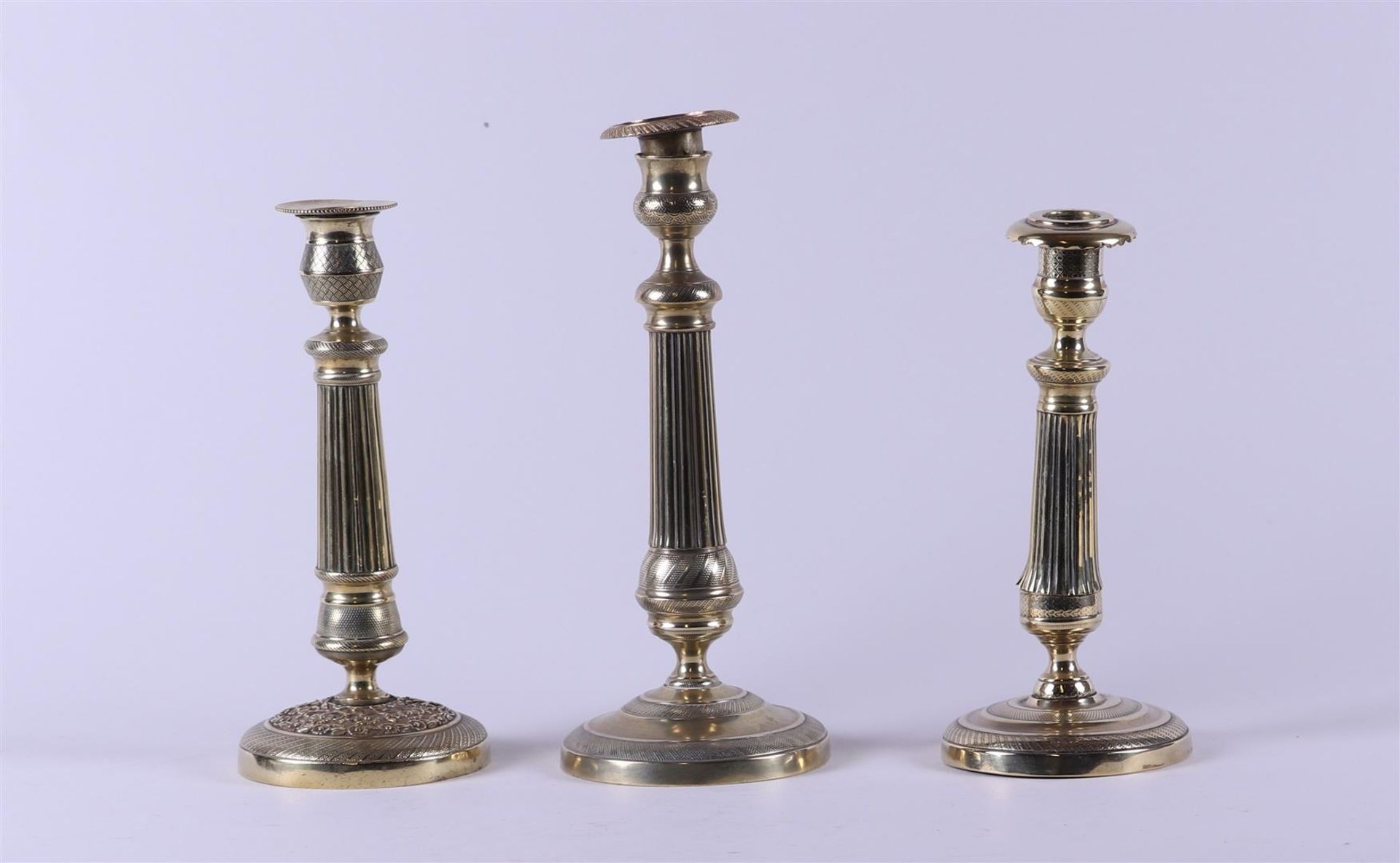 A lot consisting of (3) bronze early 19th century (Empire) candlesticks.