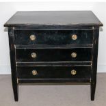 A black lacquered chest of drawers.