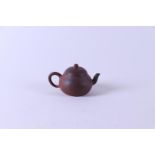 A Yixing teapot, marked on the bottom. China, 19th century.