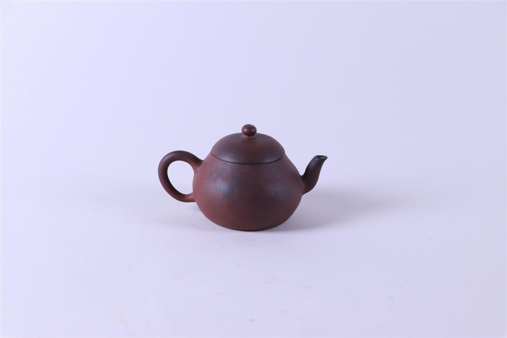 A Yixing teapot, marked on the bottom. China, 19th century.
