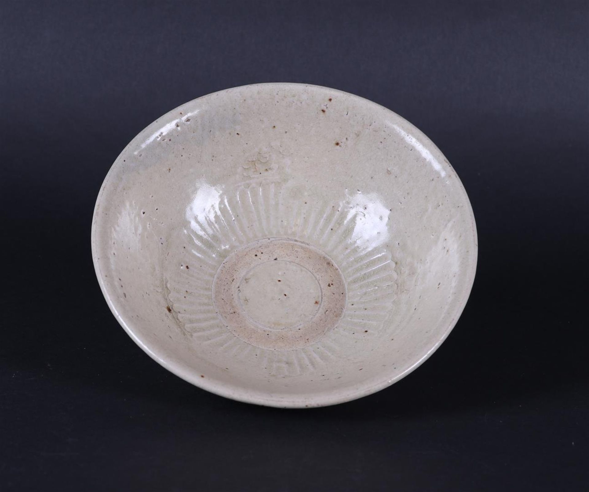 A gray Celadon bowl with ribbed center relief decoration. China, Early Ming period. - Image 2 of 3