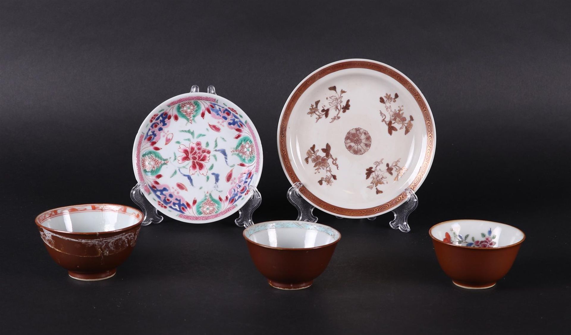 Two porcelain Famille Rose plates and three bowls, all with floral decor