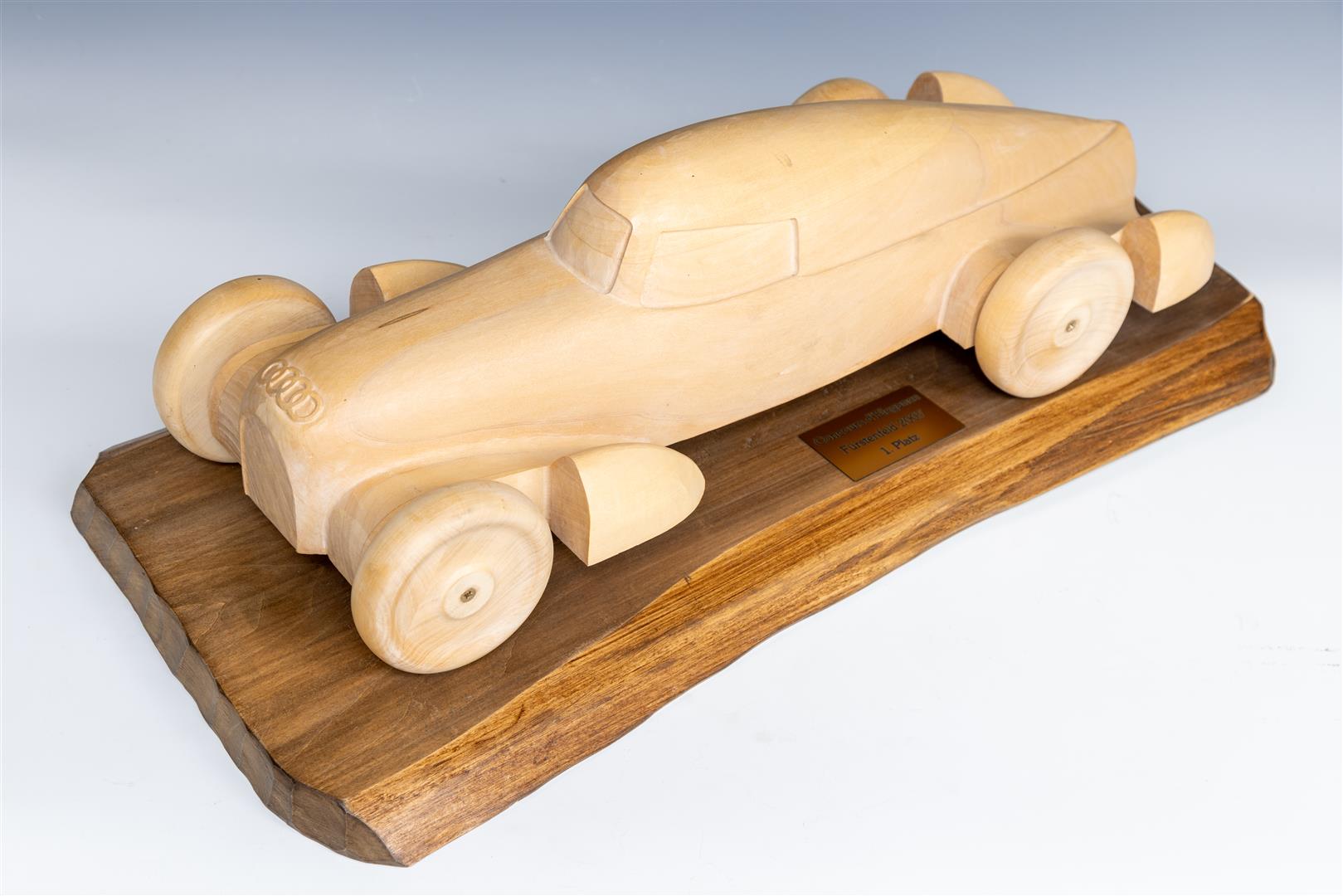 A wooden carving depicting Auto Union silber pfeil, prize for Cours d'elegance, 2007.