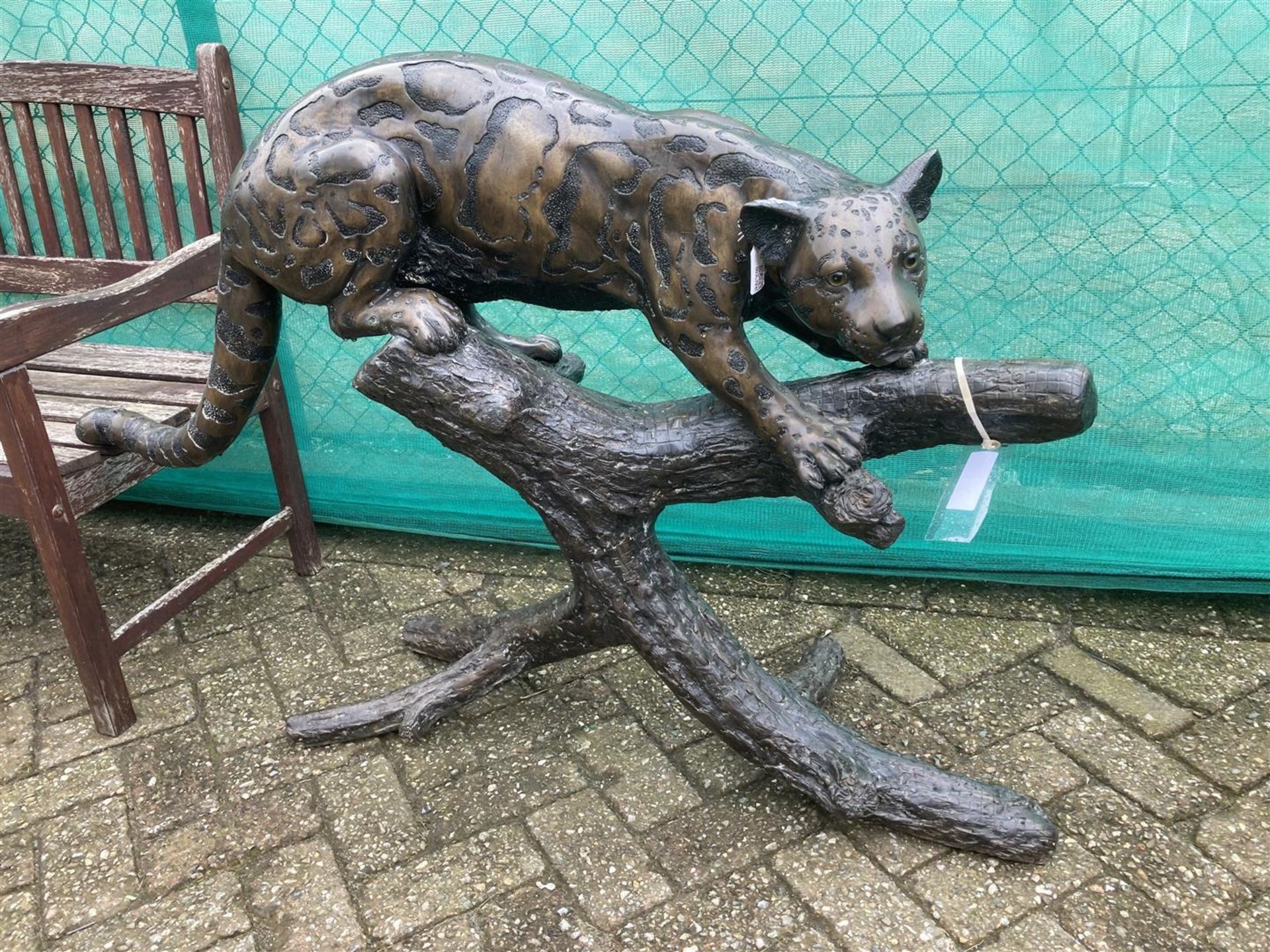A dark patinated bronze of a cat-like on a tree stump. Second half 20th century.