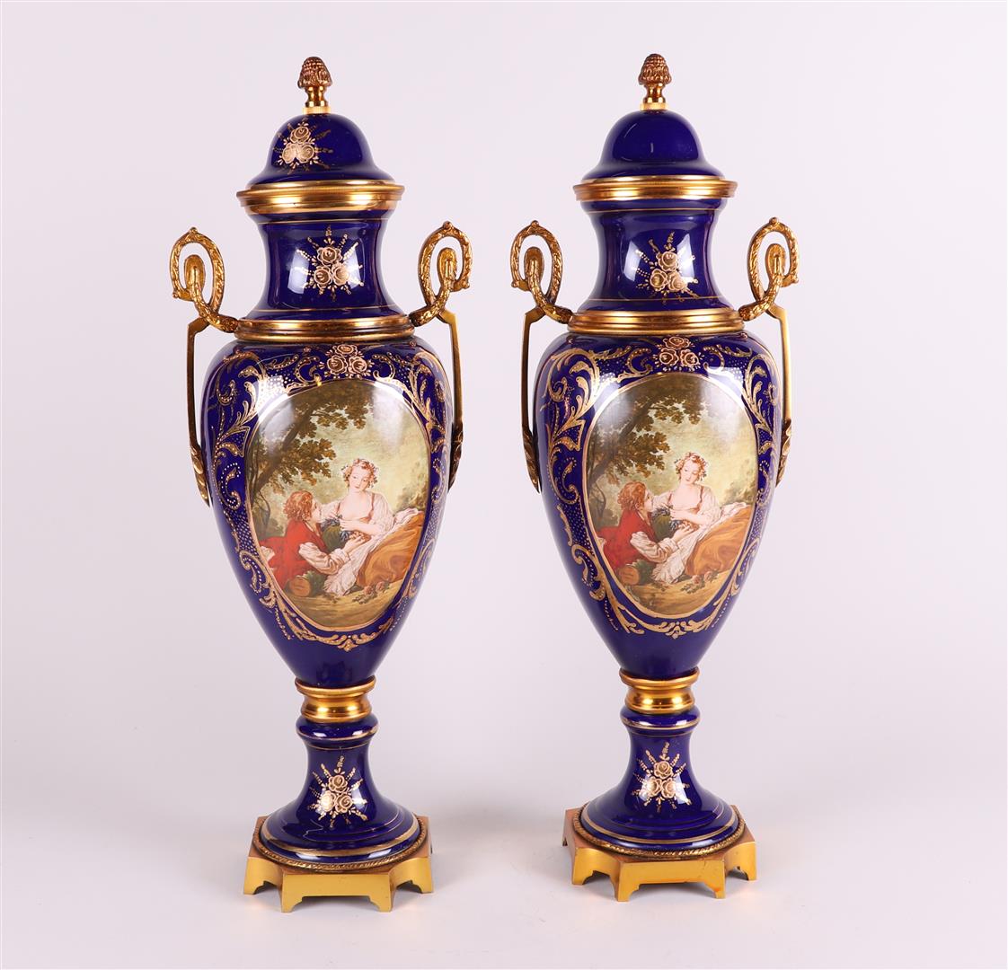 A set of two Sèvres-style porcelain vases with brass mounts. France, 20th century.