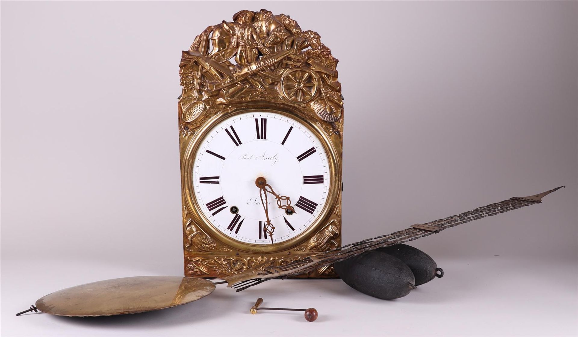 A French comtoise clock with laton copper decoration in the crest.