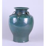 A green-glazed earthenware vase. China, 20th century.