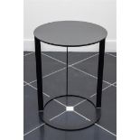A design table with a plastic top on a metal base.