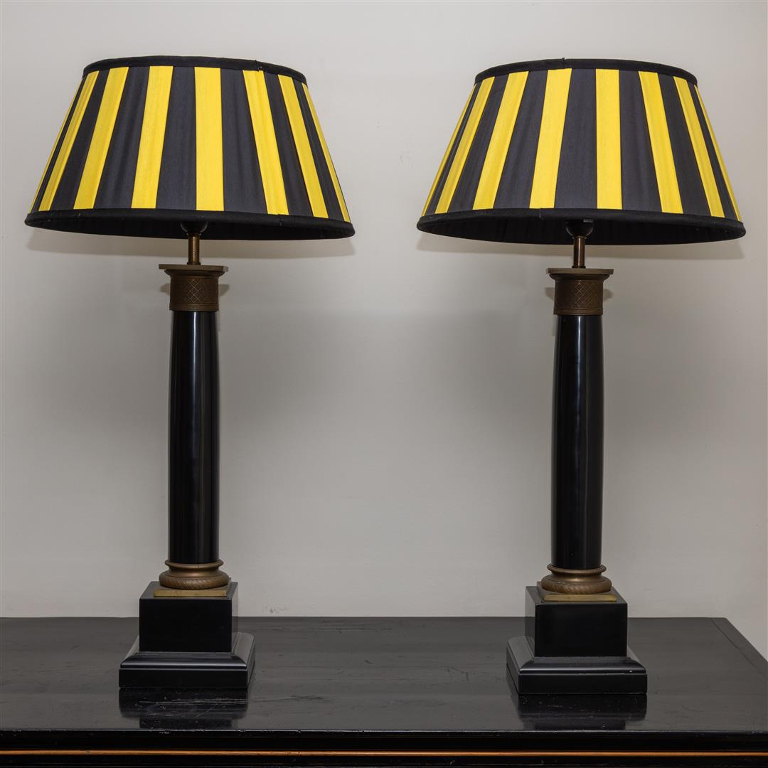 A set of (2) table lamps in the shape of a column with yellow-black shades.