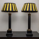 A set of (2) table lamps in the shape of a column with yellow-black shades.