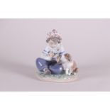 A porcelain group of a boy with a dog. Lladro, Spain.