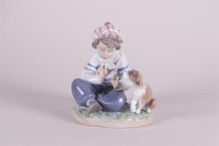 A porcelain group of a boy with a dog. Lladro, Spain.