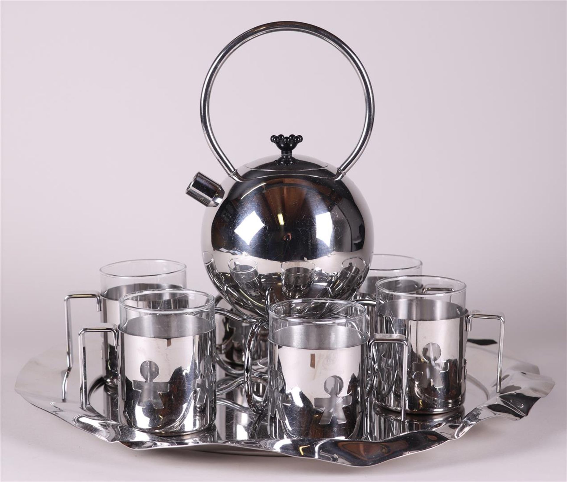 A design tea set consisting of a WMF teapot with tea light holder and Alessi tea mugs.