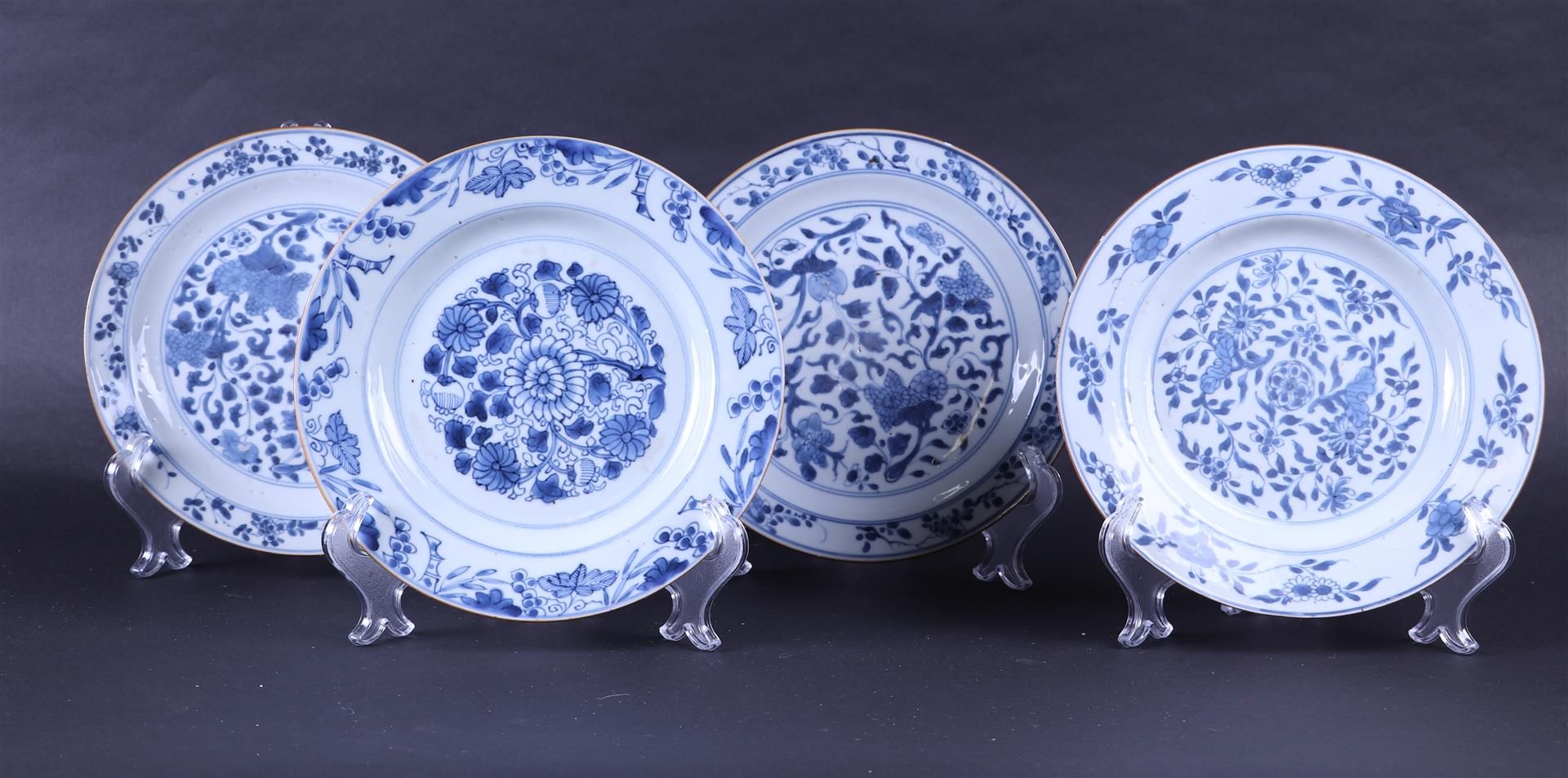 A lot of four porcelain plates with a floral decor. China, 18th century.