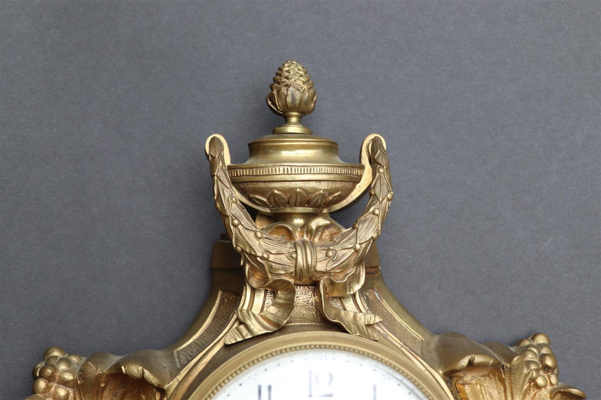 An ormolu plated cartel clock decorated with vase work and garlands, France late 18th century. - Image 3 of 4