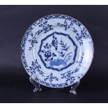 A porcelain dish with floral decoration in the center and with a diamond/box outer edge.