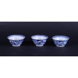 Three porcelain cups with honeycomb relief decor and rich lotus flower decoration.