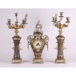 A French Garniture de Chéminé or clock set, consisting of a mantel clock and two candlesticks.