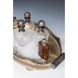 A lot consisting of a silver-plated tray, three decanters, and a liquor bottle in a leather case.