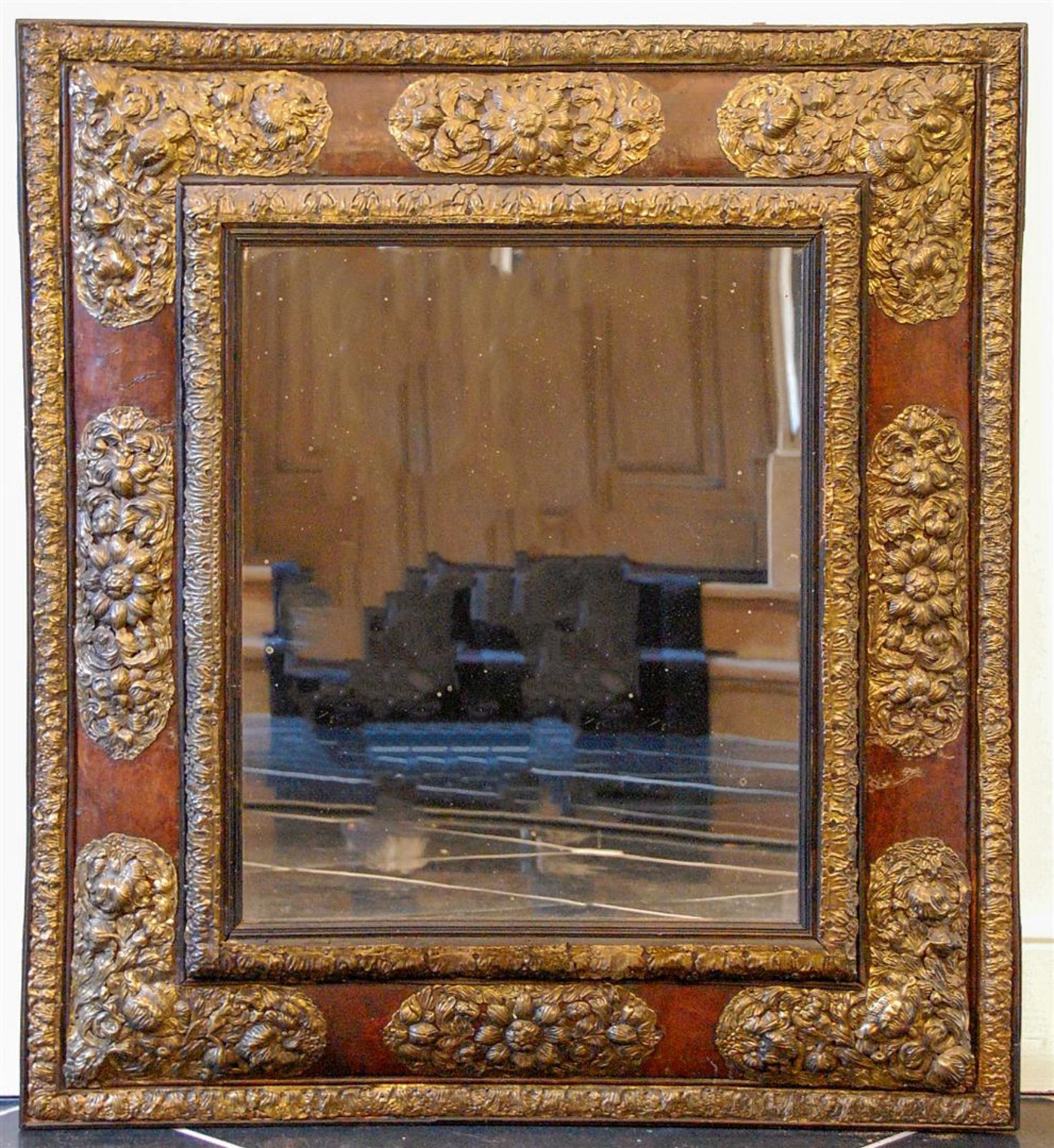 A 19th century mirror with laton copper decorations.