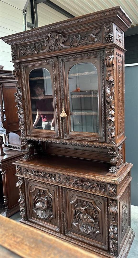 A French, antique hunting cupboard, the revolt carried by abstracted lions, with glass doors 