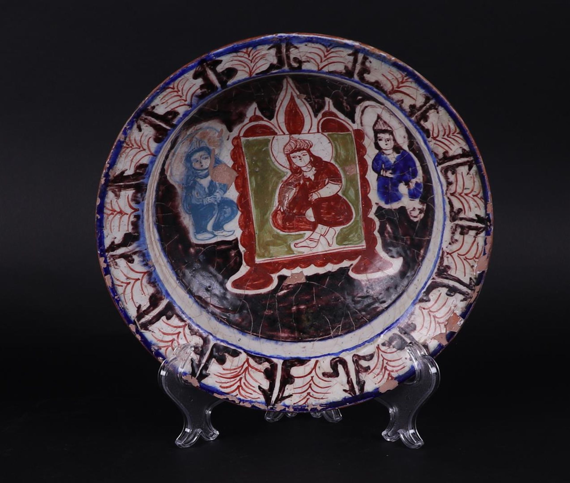 An earthenware Nishapur bowl with floral decor and decorated in the center with a figure. 